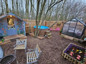 a backyard with a play house and a playground at The Garden in Hambleton