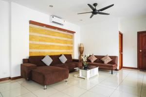 a living room with two brown couches and a ceiling fan at Luxury Massarossa Pool Villa Pattaya-21 in Pattaya Central +46 photos