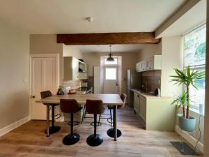 a kitchen with a wooden table and chairs at The Farmhouse Snug in Spean Bridge