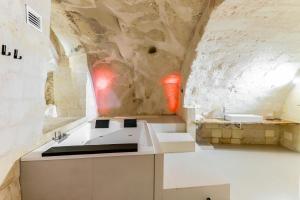 a bathroom with a sink and a stone wall at Angelica Home - Central apartment in Matera in Matera