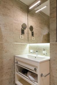 a bathroom with a sink and a mirror at ZEPTERME Luxury Apartments & Studios by CENTRAL in Vrnjačka Banja +66 photos