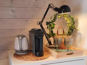 a black lamp sitting on a table with wine glasses at Babie Lato b&b in Uniejow