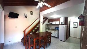 a kitchen with a dining room table and a staircase at Cabañas Brochero del Valle in Villa Cura Brochero