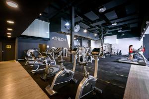 a gym with a bunch of cardio equipment in it at Hotel Carat Apart Boutique in Rosario