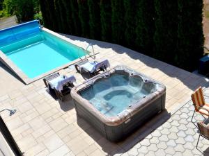 an overhead view of a jacuzzi tub with two chairs at Apartmani HARMONIJA - Sokobanja in Soko Banja