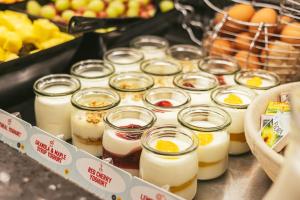 a bunch of jars filled with eggs and fruit at Point A Hotel London Shoreditch in London