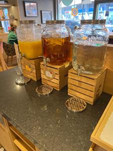 two large glass vases sitting on top of a counter at Point A Hotel London Shoreditch in London