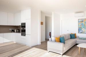 a living room with a couch and a kitchen at Marco 4 Seasons- Spring in Arco da Calheta