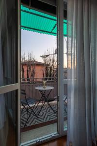 a sliding glass door with a table on a balcony at HouSmart Lorenzo Costa 17 in Bologna