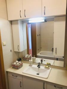 a bathroom with a sink and a large mirror at Casa Blanca in Nyíregyháza +41 photos