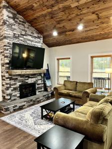 a living room with two couches and a fireplace at Cozy 3 BR Cabin with Pond on 3 acres - New River Gorge - Summersville Lake in Mount Lookout +44 photos