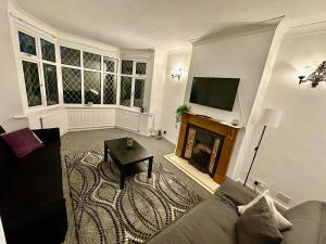 a living room with a couch and a fireplace at Spacious 4 Bed Home Near NEC, JLR & Airport Parking for 3 Cars Ideal for Contractors! in Olton