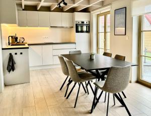 a kitchen and dining room with a table and chairs at Vitamin Sea in Oostduinkerke