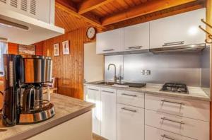 a kitchen with a coffee maker on a counter at Chalet 5 personnes California Park in Cabourg