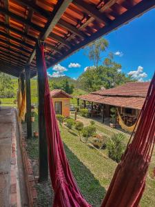 a couple of hammocks hanging from a building at Pousada e Restaurante Casarão in Passa Quatro