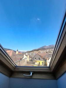 a window with a view of a city at Ferienhaus Stadt Juwel in Mürzzuschlag +3 photos