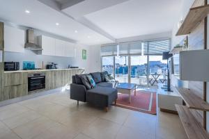 a living room with a couch and a table at Bright and modern apartment in St Julian's