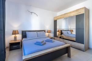 a bedroom with two beds and a large mirror at Bright and modern apartment in St Julian's