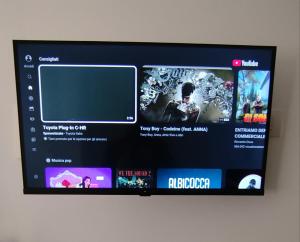 a television screen with several videos on it at Town Center Apartment in Cagliari