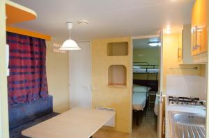 a small kitchen with a table and a sink at Kamemi Village & Camping in Ribera