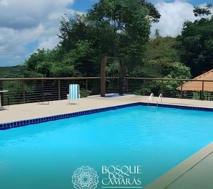 a large swimming pool with blue water at Ground Floor Flat in the Midst of Nature in Camaragibe