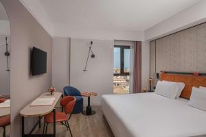 A bed or beds in a room at NH Catania Centro