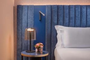 A bed or beds in a room at NH Catania Centro