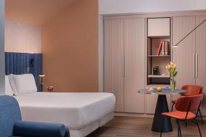 A bed or beds in a room at NH Catania Centro