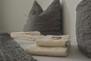 two towels sitting on top of a bed with pillows at Hotel Merlin in Cologne +4 photos