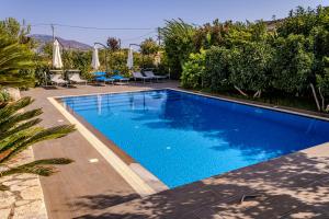 a swimming pool with blue water in a yard at Villa La Quiete - Adults only in Ksamil +61 photos