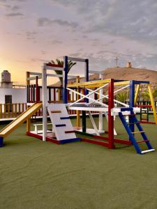 a playground with colorful equipment on the grass at Beach house Sol Mar y Relax in Cerro Azul