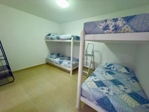a room with two bunk beds and a ladder at Beach house Sol Mar y Relax in Cerro Azul +14 photos