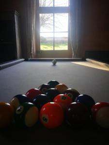 a group of billiard balls on a pool table at Maison de maître sur grand terrain in Mézilles