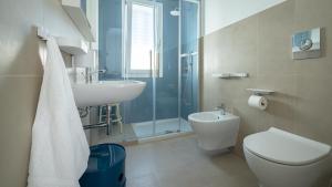 a bathroom with a sink and a toilet and a shower at Casa BON BON in Triscina