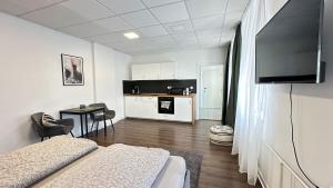 a room with two beds and a flat screen tv at Apartman Vita Lite in Trenčín