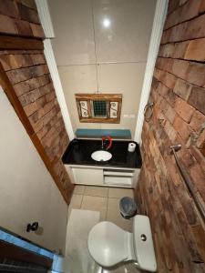 a small bathroom with a sink and a toilet at Flat aconchegante 1 Vila Rica ao lado Mineirão Pampulha BH in Venda Nova +19 photos