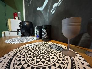 a table with a table cloth and a glass at Flat aconchegante 1 Vila Rica ao lado Mineirão Pampulha BH in Venda Nova