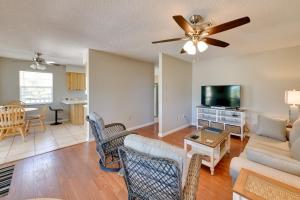 a living room with a couch and a tv at Coastal Oasis with Shared Pool, 2 Mi to Beach! in Englewood