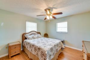 a bedroom with a bed and a ceiling fan at Coastal Oasis with Shared Pool, 2 Mi to Beach! in Englewood +17 photos