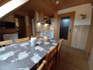 a dining room with a table and chairs in a kitchen at Ferienwohnung - Landhotel Waldschlößchen in Sohland