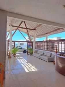 a pavilion with couches and a car in a building at Pousada leblon in Caucaia