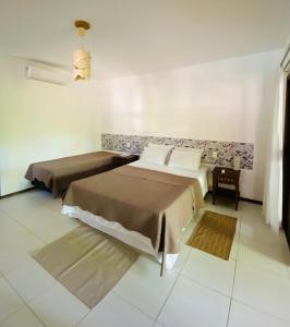 マラウにあるFlat Ewa Condomínio beira-mar Varanda Piscinaの部屋にベッドが2つある寝室