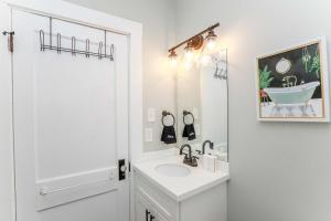 a white bathroom with a sink and a mirror at Sojourn at Colley Manor Unit 5 Sleeps 4 in Norfolk