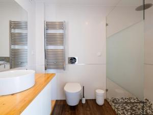 a white bathroom with a sink and a toilet at Apt. dos Correios in Lagos +13 photos