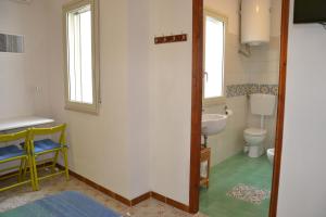 a bathroom with a sink and a toilet at B&B Talìa in Scopello