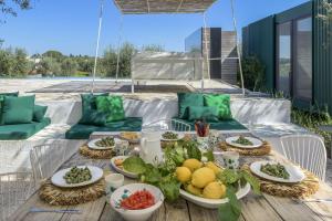 a table with plates of food on a patio at Cocotrullo in Cisternino