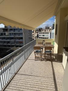 a balcony with a table and chairs on a building at Cecilia's cozy apartment in Athens