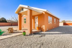 a small orange house on a gravel lot at 3 Mi to Elephant Butte Lake Cozy Retreat! in Truth or Consequences