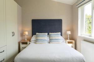 a bedroom with a large white bed with two pillows at Croyde Bay Hotel or Self Catering in Croyde