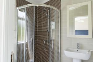 a bathroom with a shower and a sink at Croyde Bay Hotel or Self Catering in Croyde
